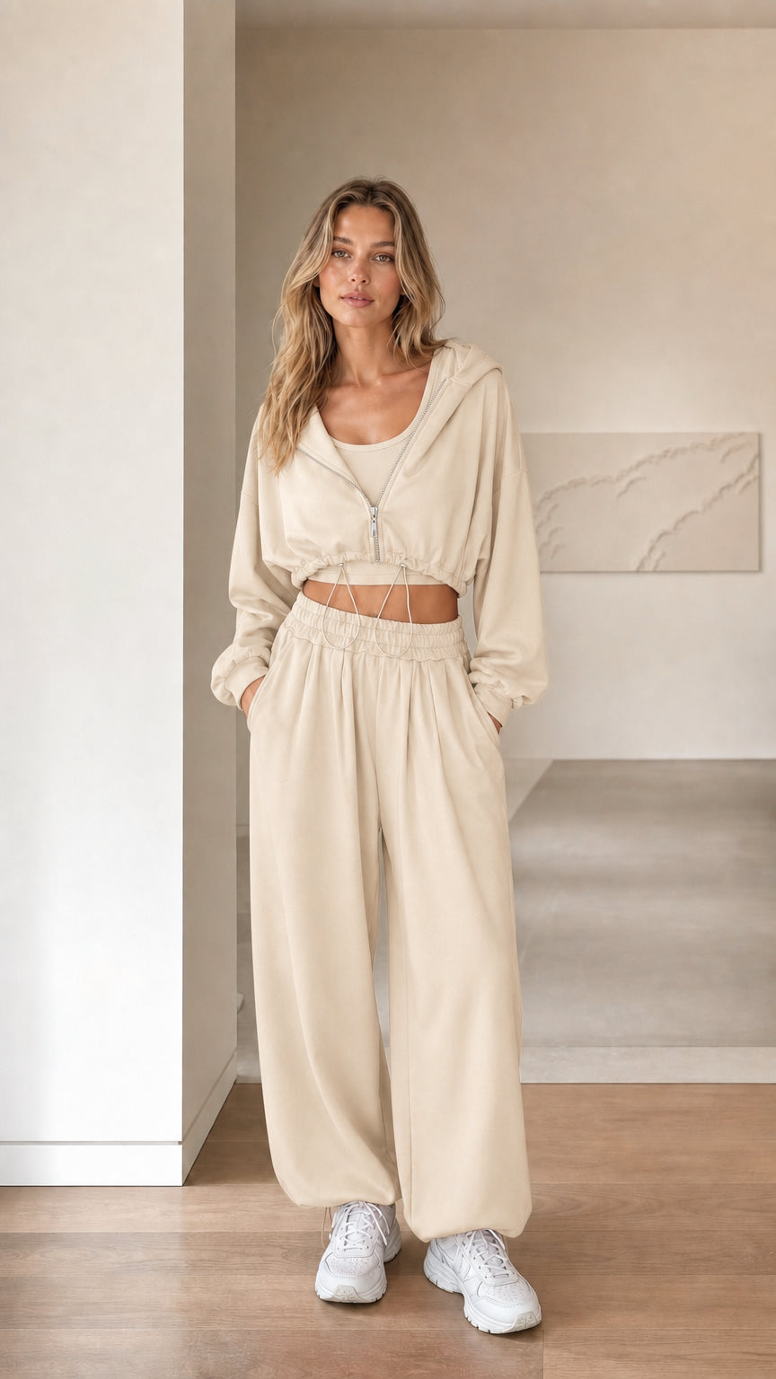 Front view of woman wearing beige cream 3-piece cropped hoodie and sweatpants set