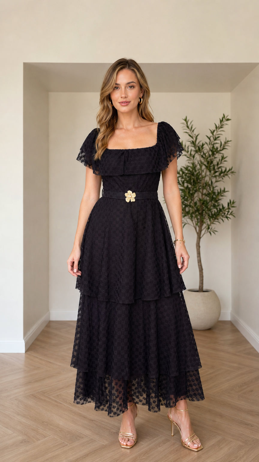 Front view of black tiered square neck maxi dress with floral buckle belt