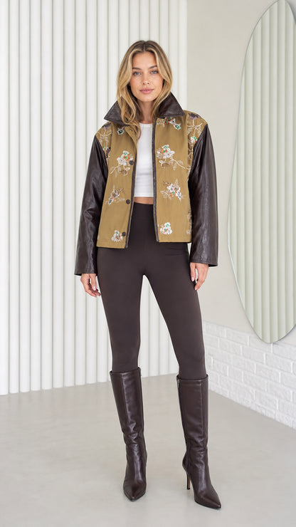 Model wearing Khaki embroidered jacket with faux leather sleeves, front view