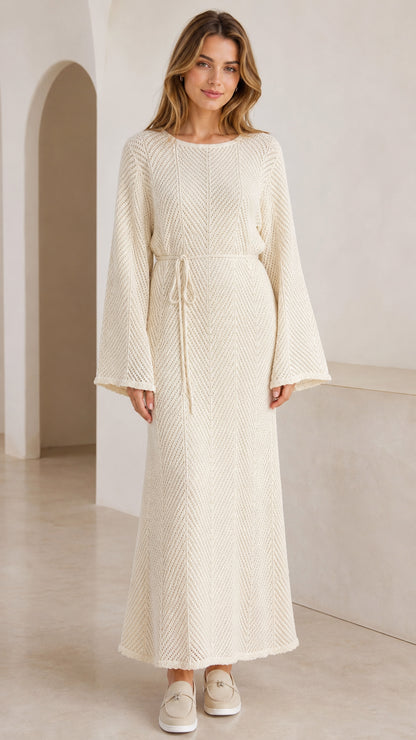 Front view of model wearing cream textured knit bell sleeve maxi dress with waist tie
