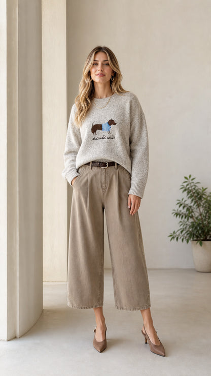 Full front view of model wearing Heather Grey dachshund embroidered sweater with wide-leg trousers