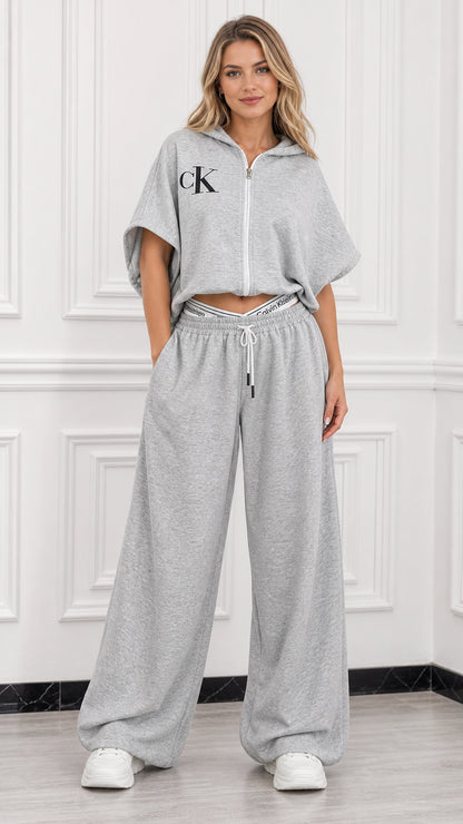 Full front view of model wearing heather grey short sleeve cropped zip hoodie and wide leg lounge pants