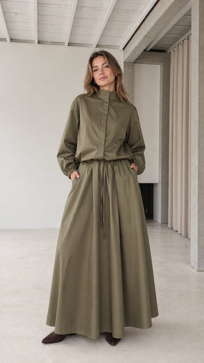 Front full view of woman wearing olive green stand collar drawstring maxi dress