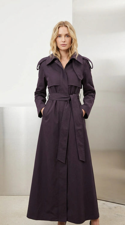 Front view of model wearing full-length deep purple belted maxi trench coat