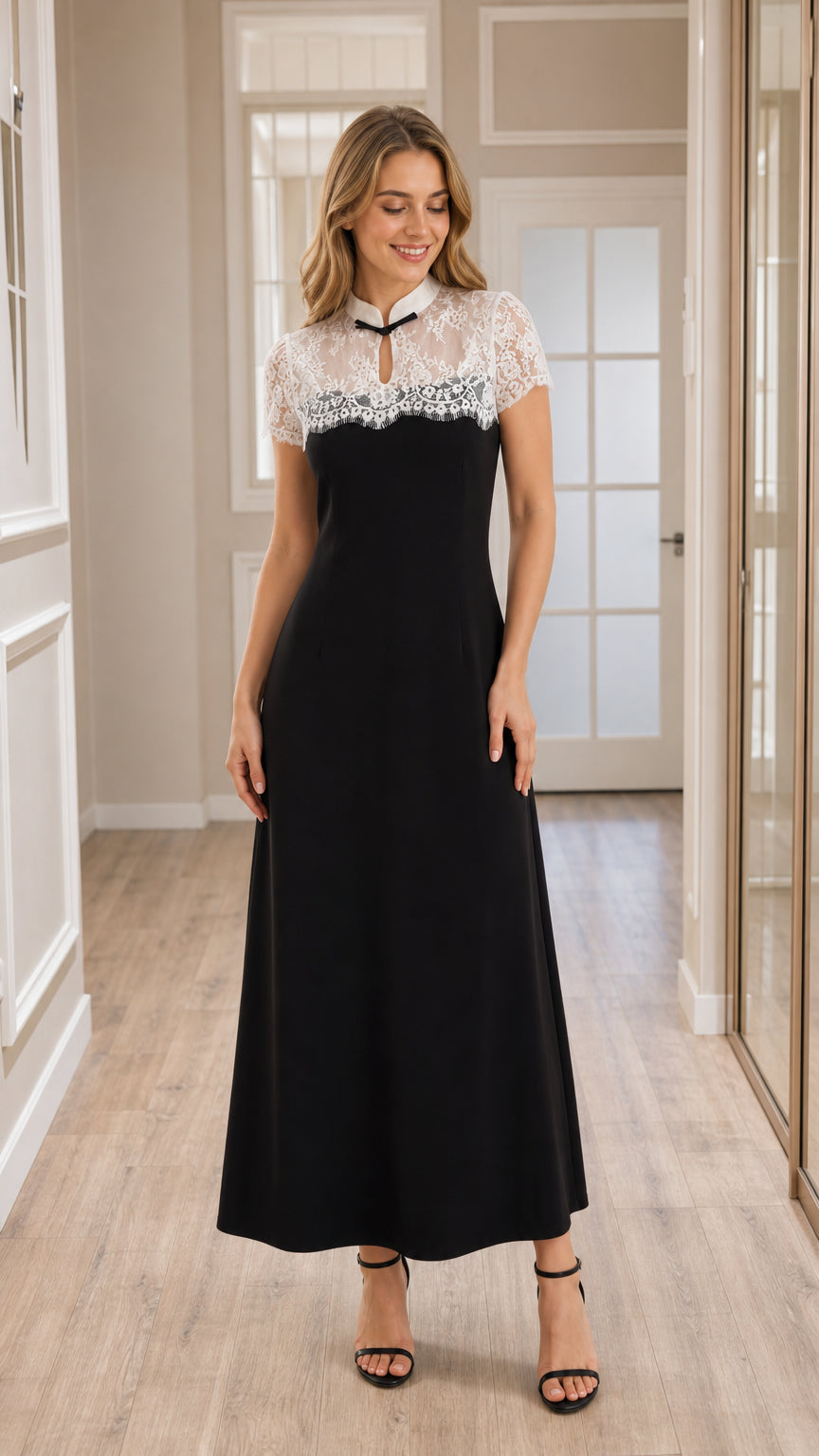 Front view of model wearing black lace yoke A-line maxi dress with keyhole collar