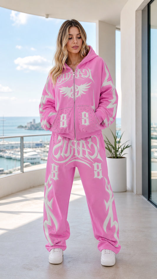 Front view of model wearing pink Y2K graphic zip-up hoodie and sweatpants set
