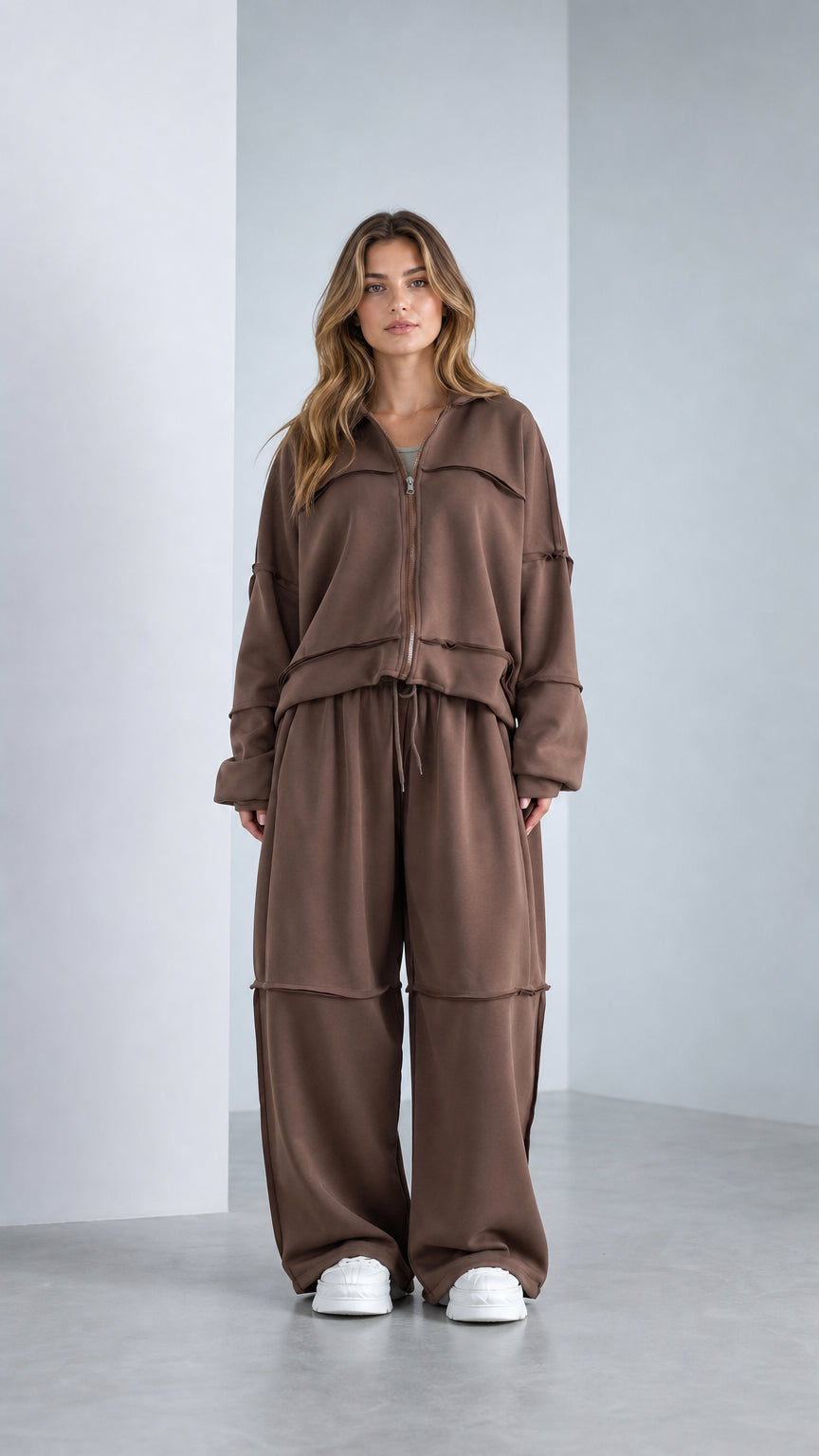 Front view of model wearing Chocolate Brown raw-edge zip jacket and wide-leg sweatpants set