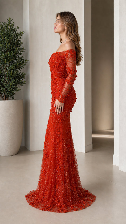 Side view of woman posing in red floral embellished long sleeve evening dress