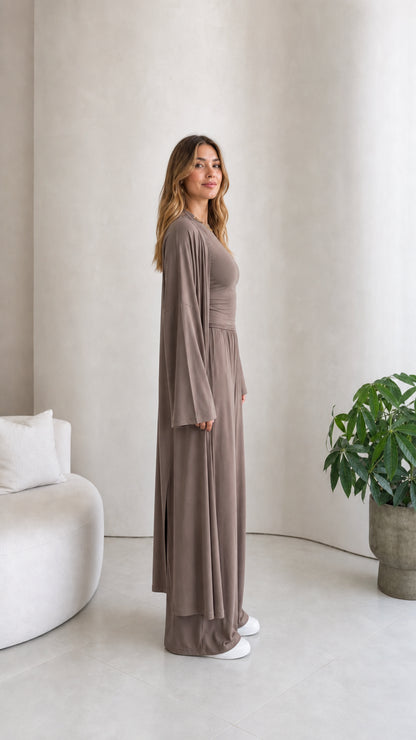 Side profile view of model wearing the taupe 3-piece duster cardigan matching set