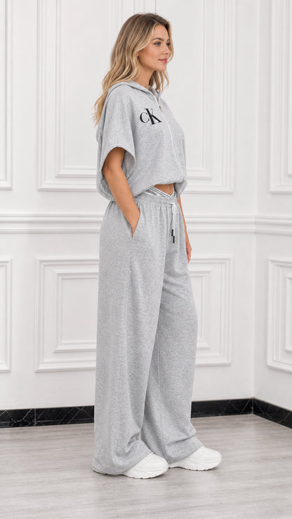 Side profile view of model wearing heather grey two piece cropped hoodie and sweatpants set