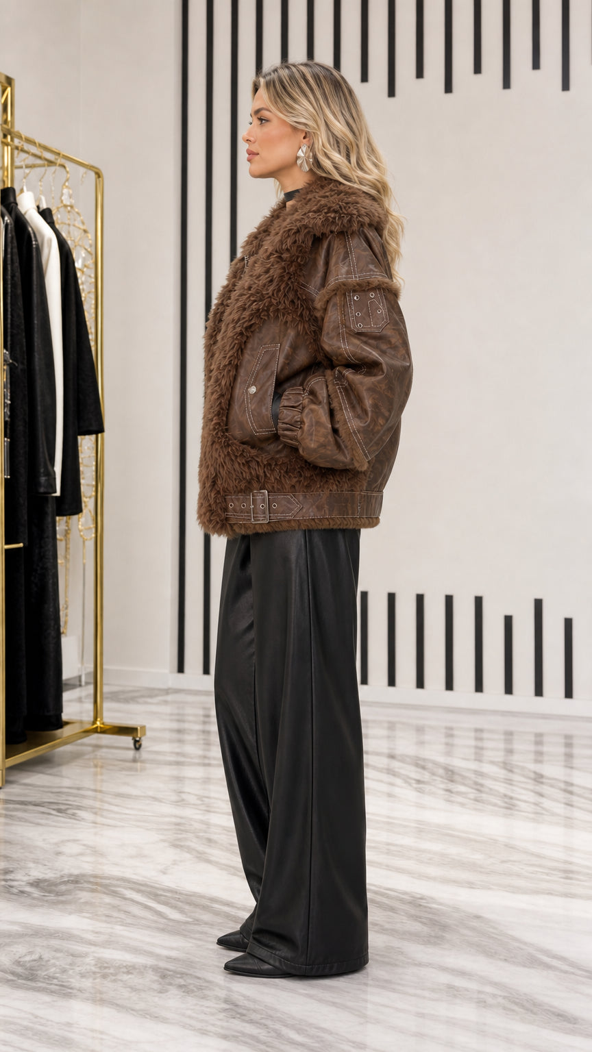 Side profile view of woman wearing brown textured faux shearling and leather jacket