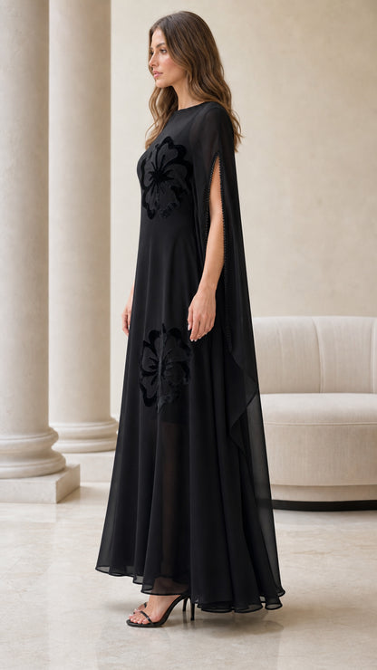 Side angle of black sheer chiffon cape dress showing split sleeves
