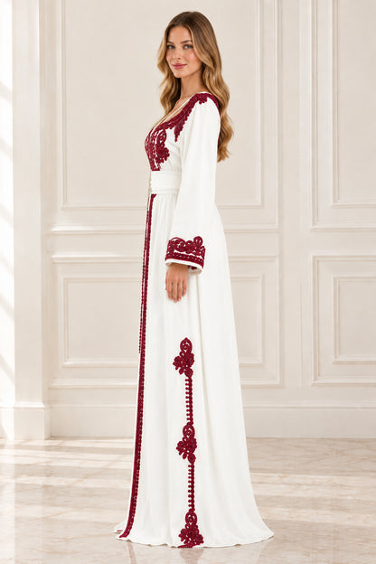 Side profile of woman wearing white embroidered kaftan maxi dress with contrast trim