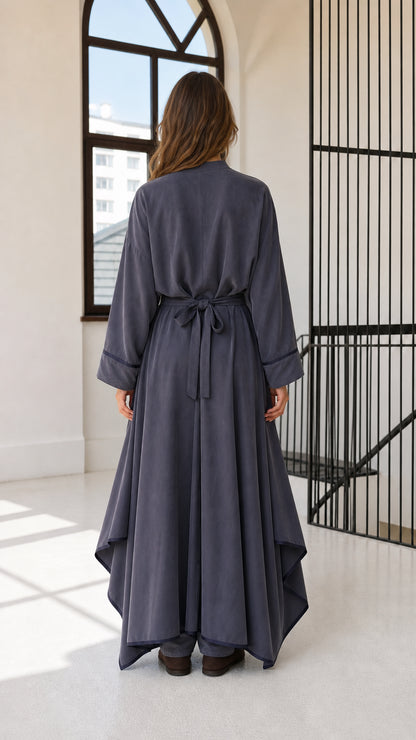 Back view of woman showing tied back waist of slate blue draped tunic matching set