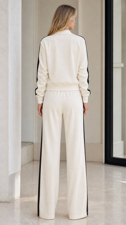 Back view of model in Cream athletic track jacket and wide-leg sweatpants
