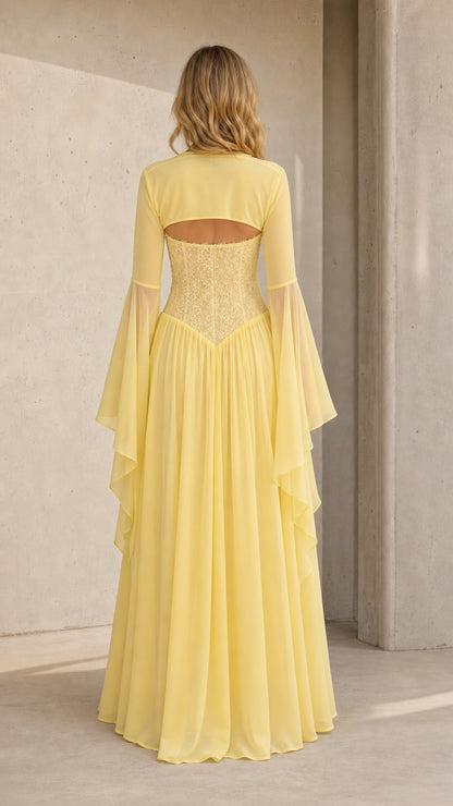 Back view of model in pale yellow maxi dress showing open back cutout detail