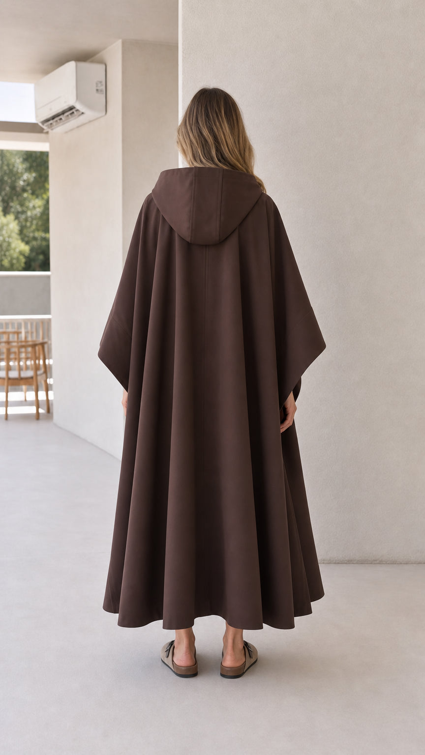 Back view of model wearing brown longline hooded cape coat