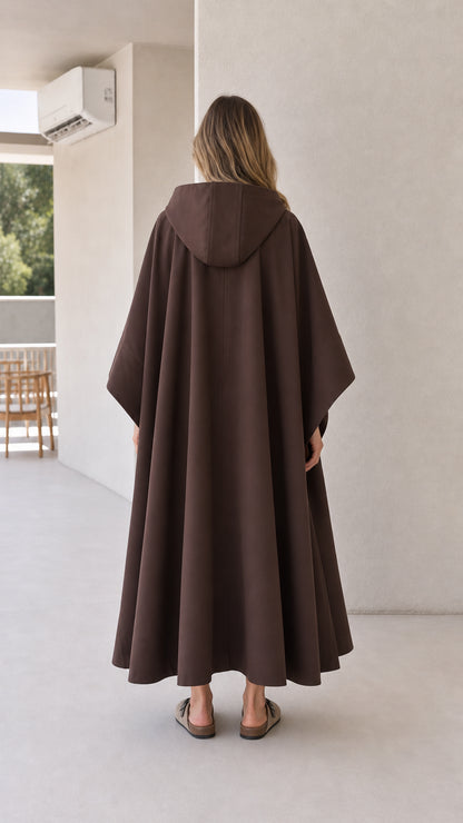 Back view of model wearing brown longline hooded cape coat