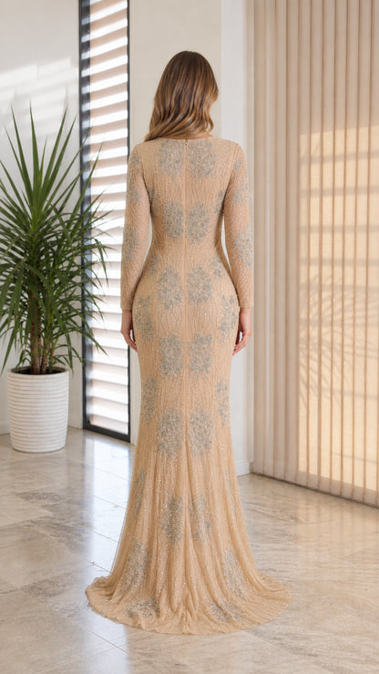 Back view of model in champagne embellished long-sleeve formal maxi gown