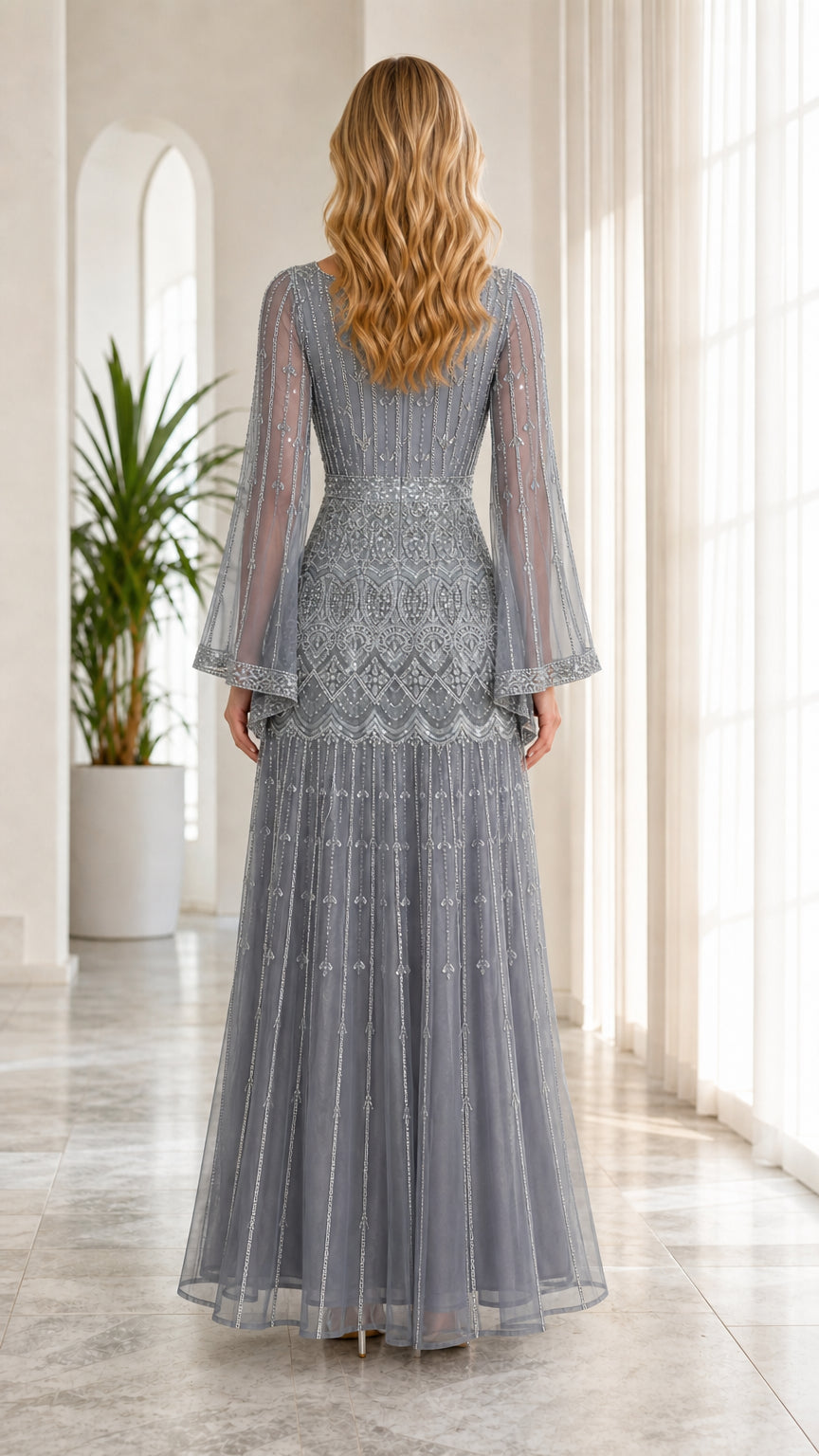Back full-length view of dusty blue beaded evening gown showing back neckline and drape
