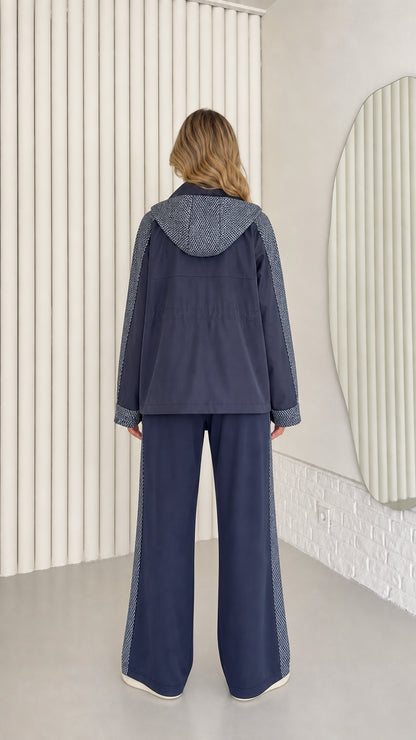 Back view of navy blue hooded tracksuit jacket and wide-leg trousers