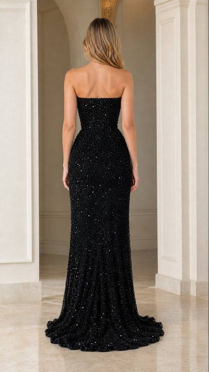 Back view of model wearing black strapless floor-length sequined dress