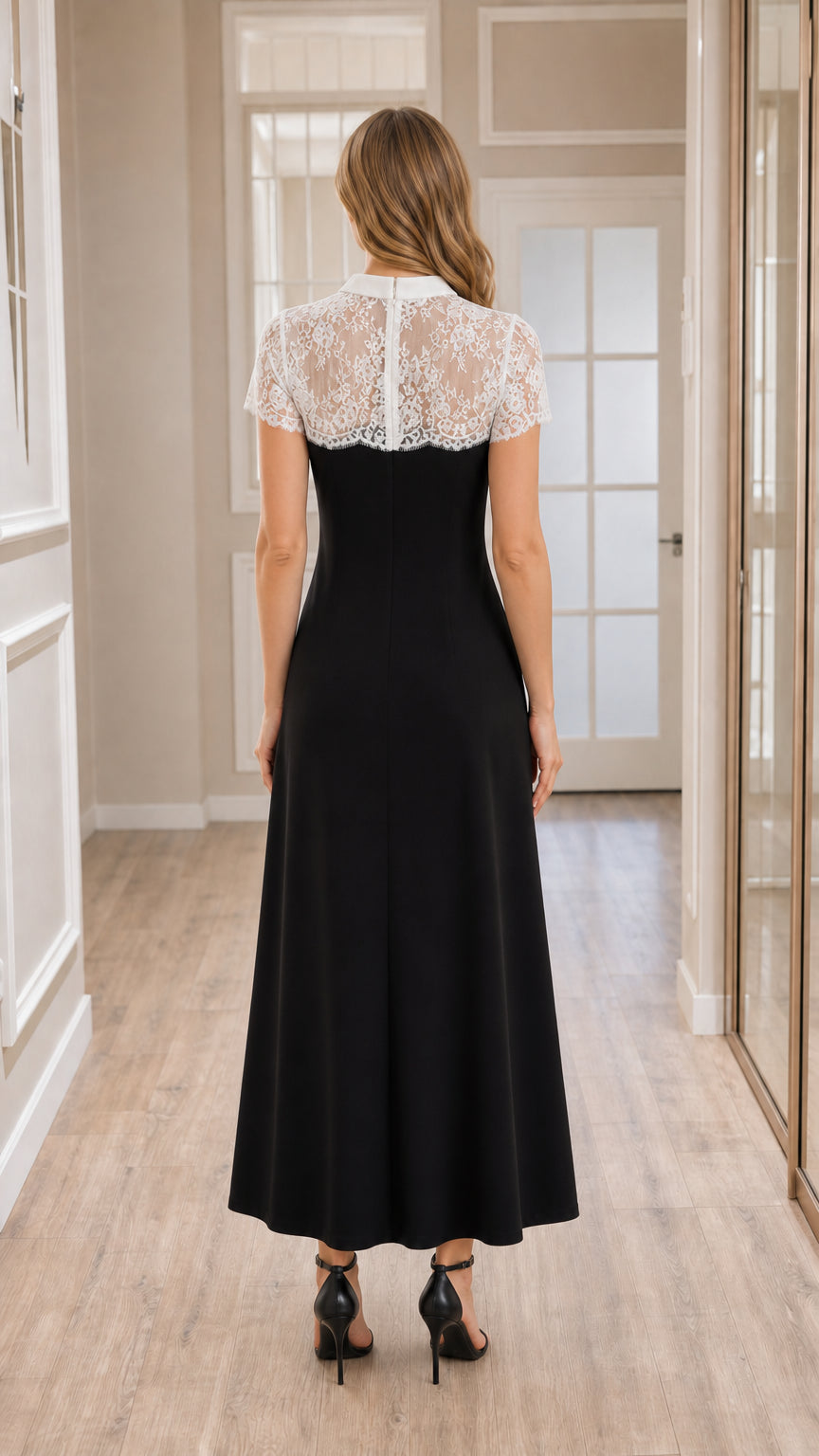 Back view of model wearing black formal maxi dress with sheer lace yoke