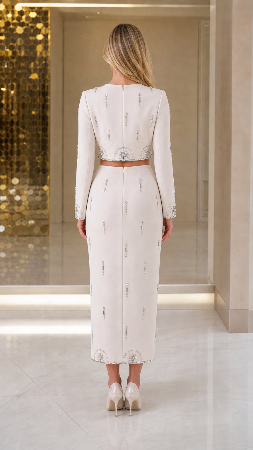 Back view of model wearing the Ivory two-piece crop top and midi pencil skirt set