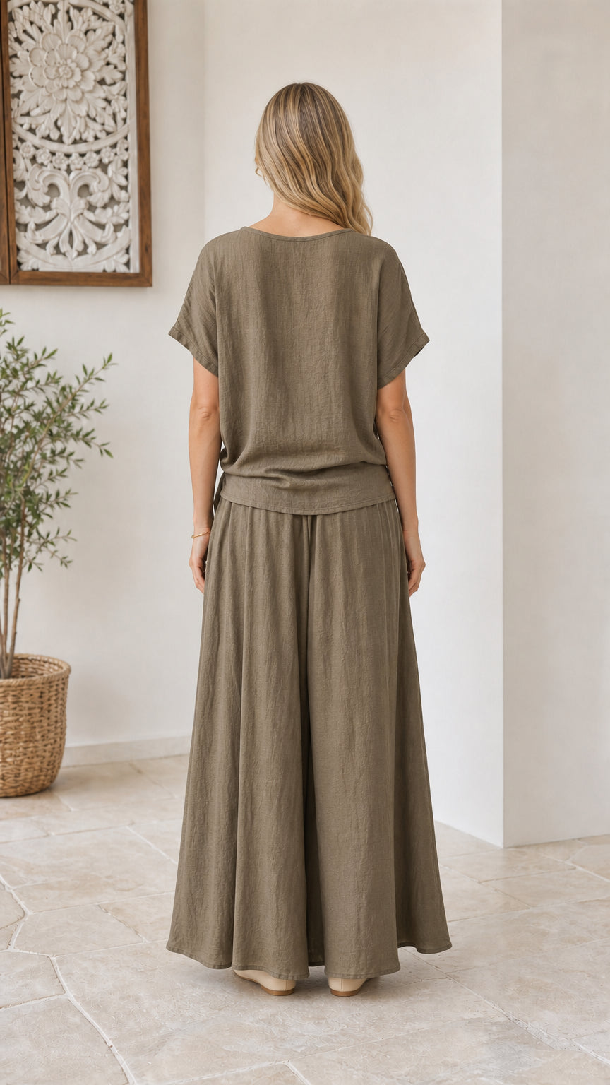 Back view of model wearing olive green wide-leg trousers and short sleeve top set