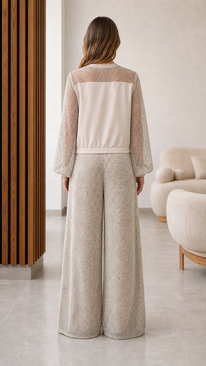 Back view of model in beige zip jacket and matching wide leg pants outfit