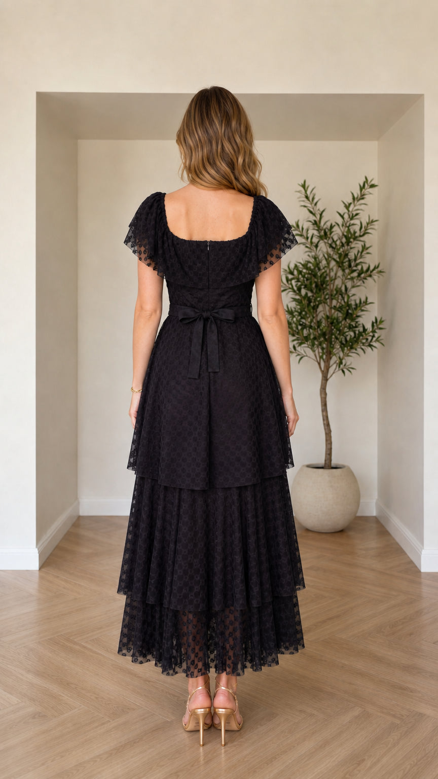 Back view of black square neck maxi dress showing waist tie