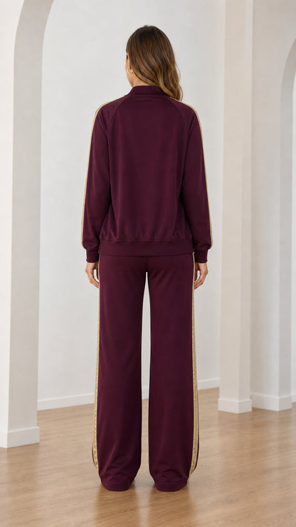 Back view of burgundy zip-up bomber jacket and wide-leg sweatpants set