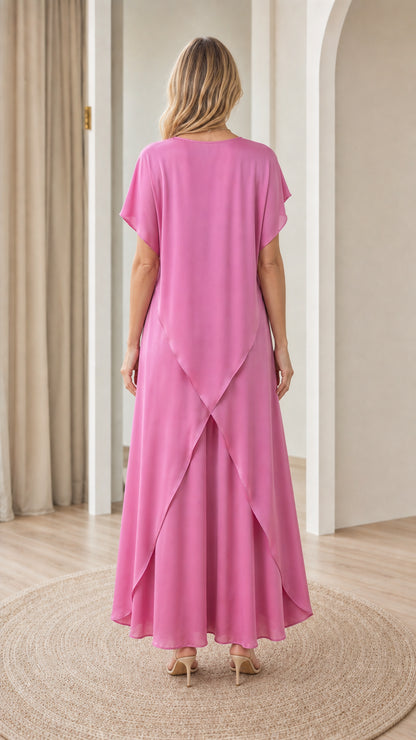 Back view of model showing the symmetrical tulip split hem detail on fuchsia pink tunic set
