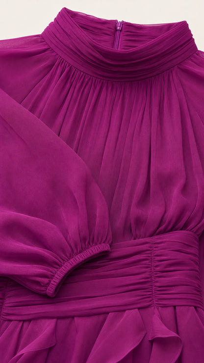 Close-up detail of pleated mock neck, back zipper, and ruched waistband on magenta dress