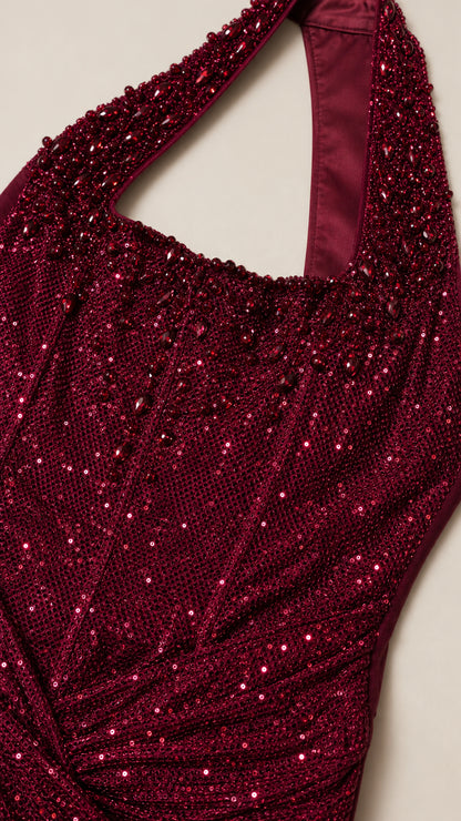 Close-up of burgundy sequin bodice with corset boning and ruching details
