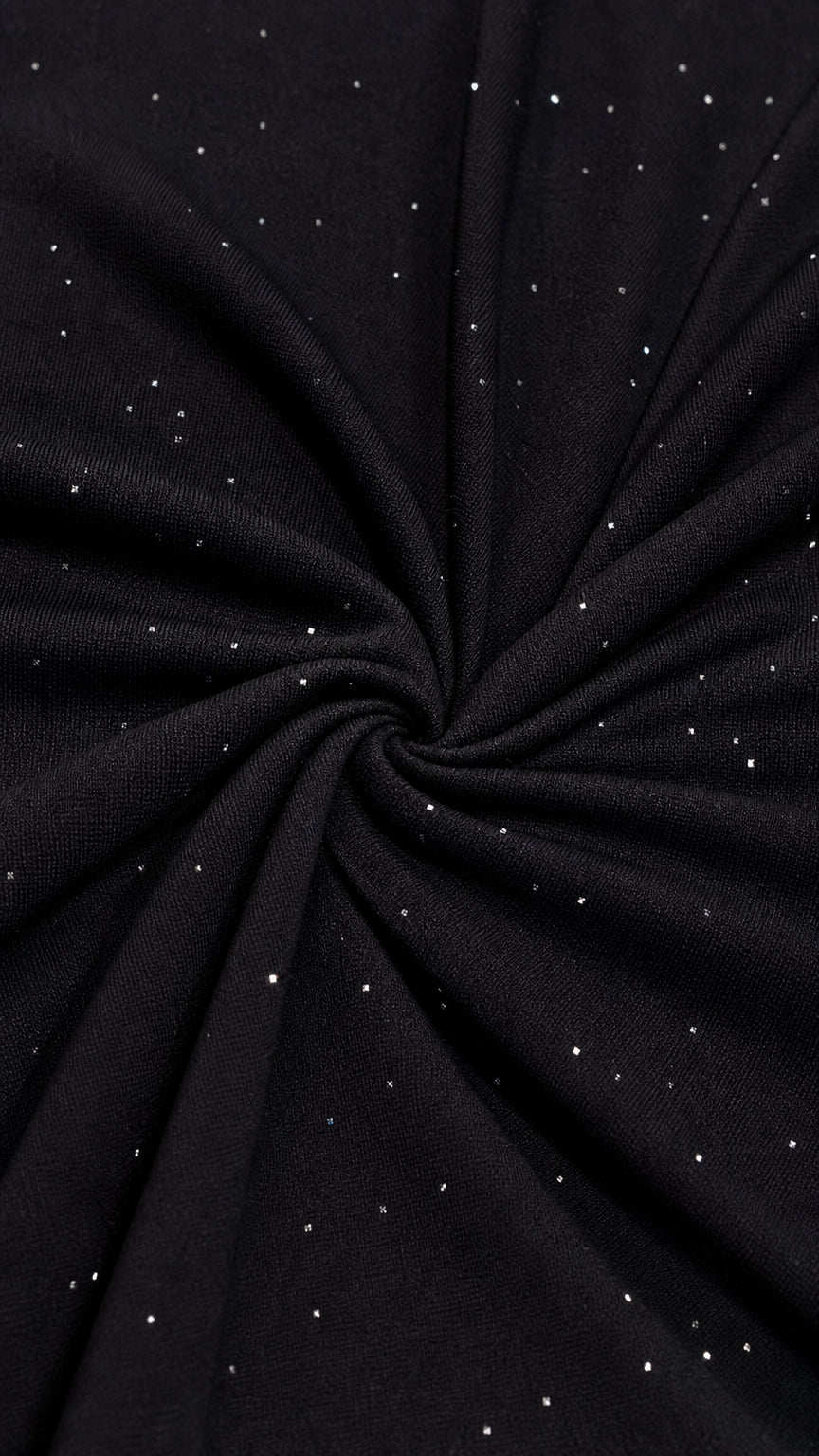 Close-up detail of black stretch fabric with delicate silver shimmer flecks
