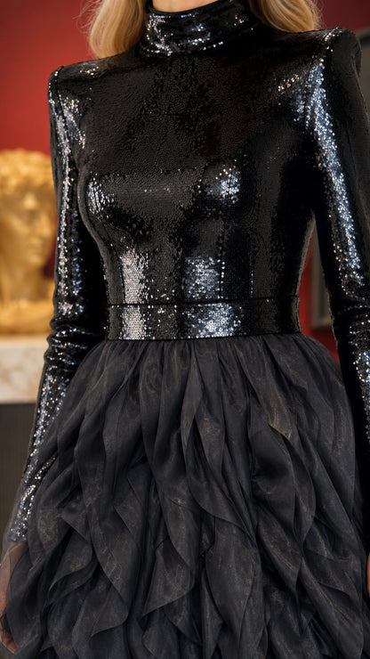 Close-up detail of shimmering black sequin bodice and textured waist ruffles