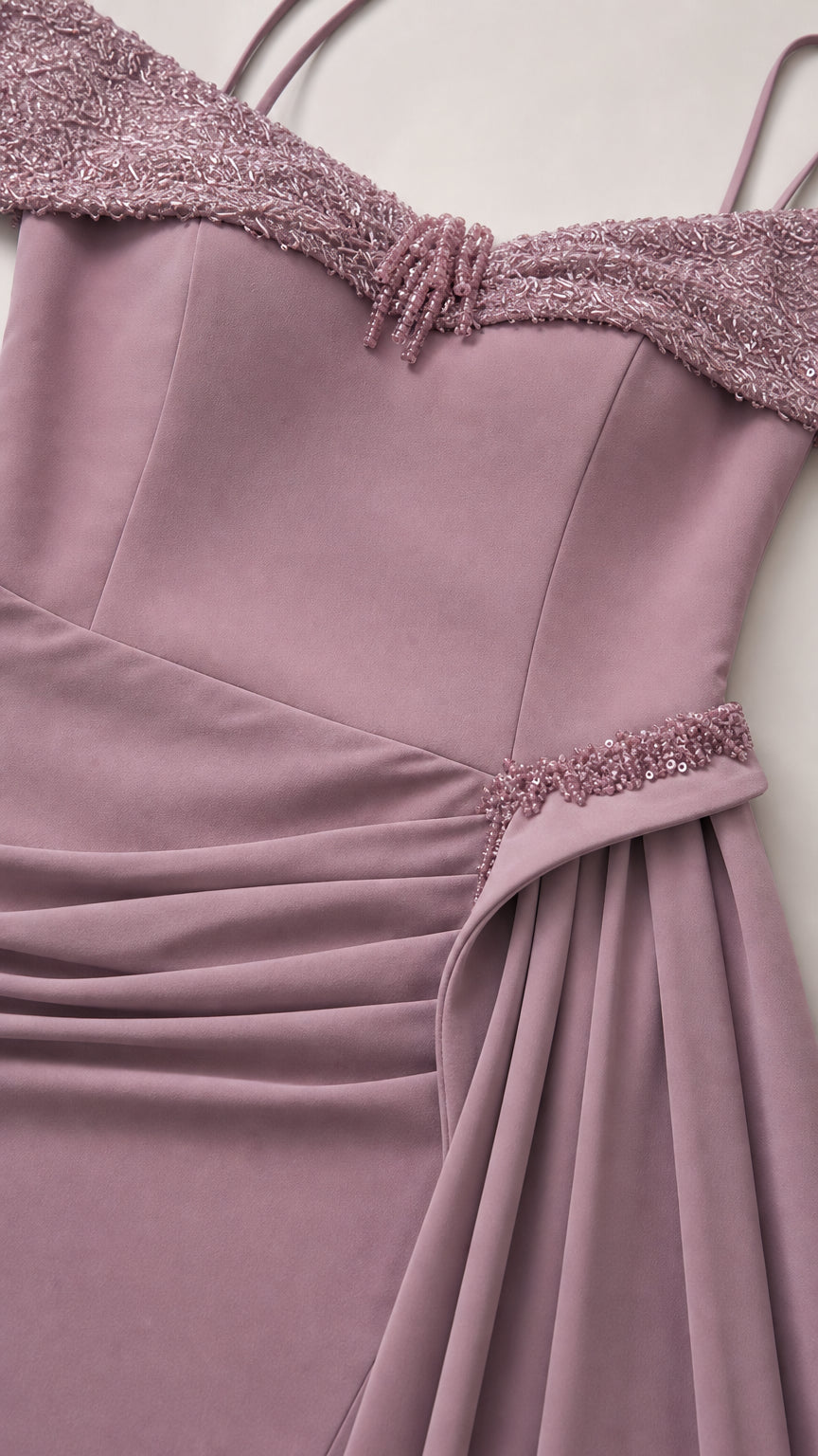 Close-up detail of beaded off-the-shoulder neckline and ruched waist trim