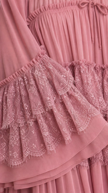 Close-up of delicate lace ruffles and pleated chiffon fabric in dusty rose