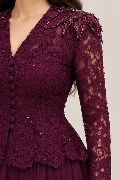 Close-up of burgundy lace bodice, covered buttons, and beaded shoulder detail