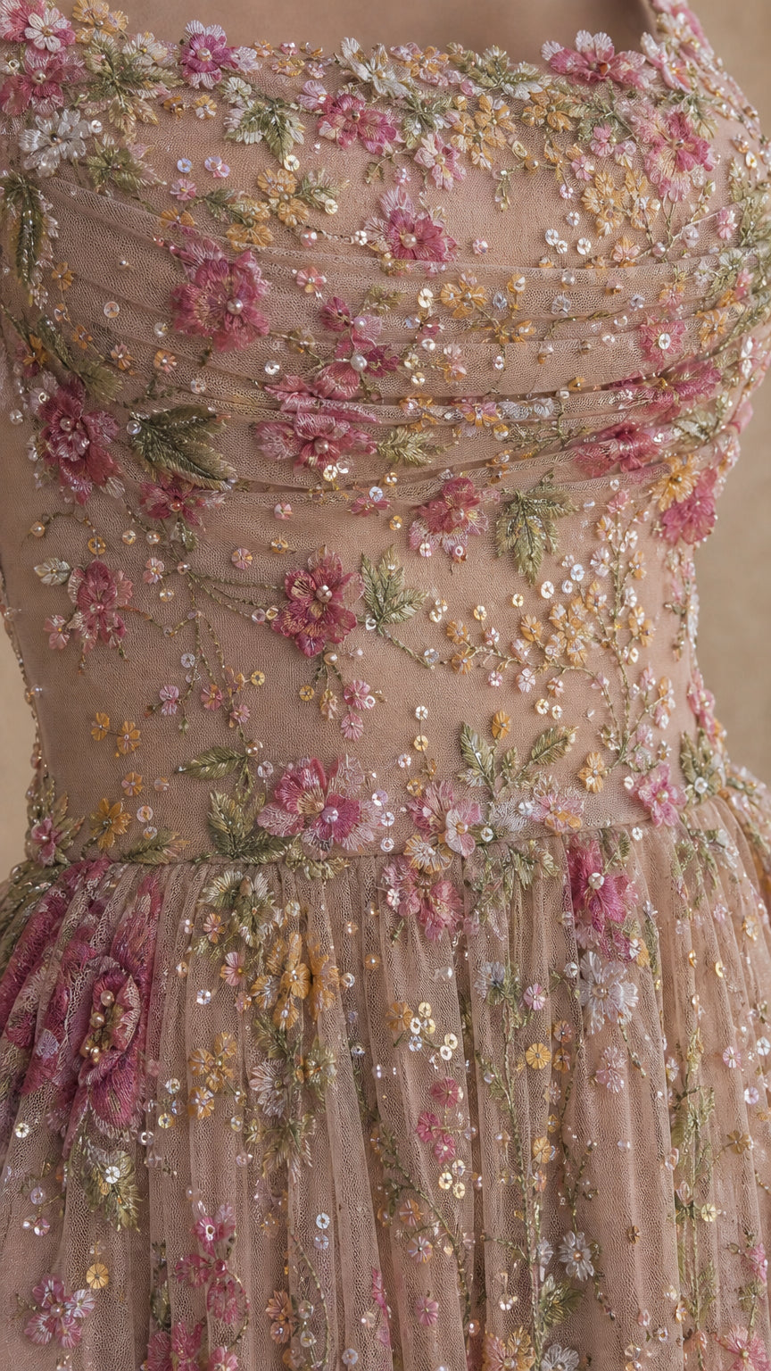 Close-up detail of textured floral embroidery and delicate sequins on bodice