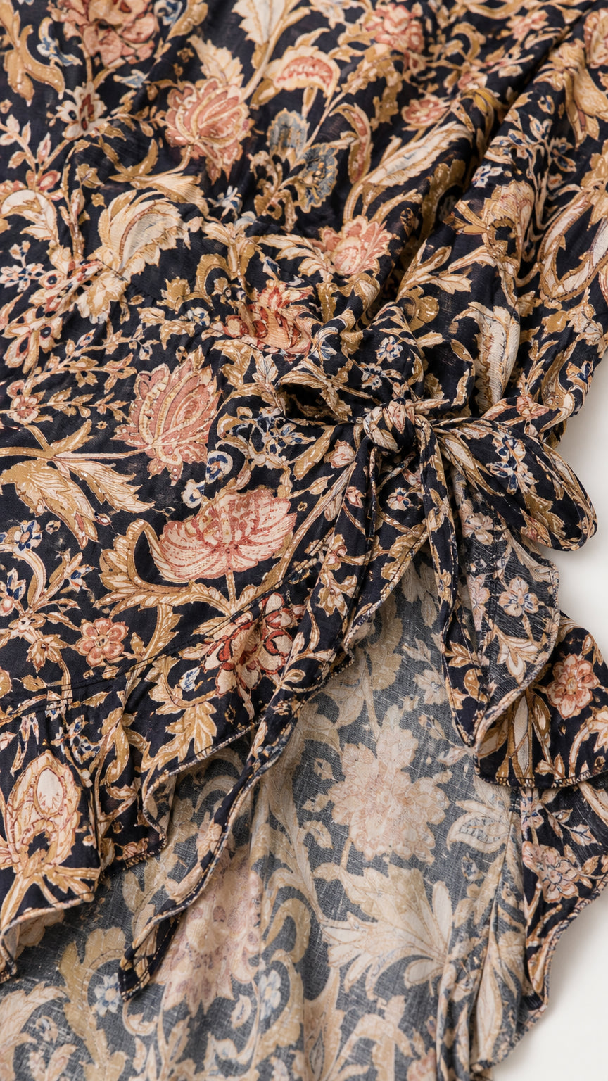 Close-up detail of the intricate paisley floral printed fabric and ruffle hem