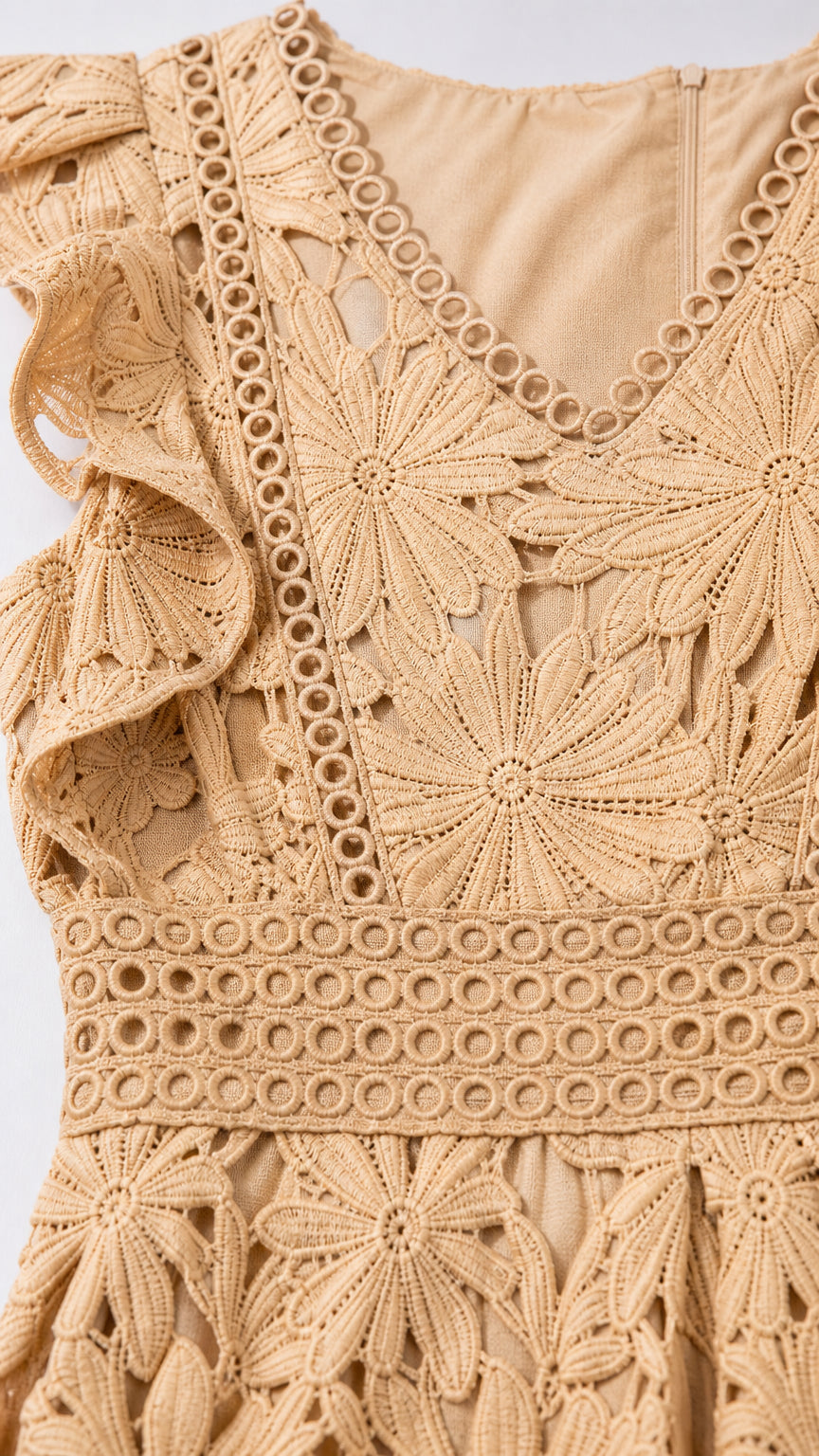 Close-up detail of beige floral lace pattern and waist ladder trim