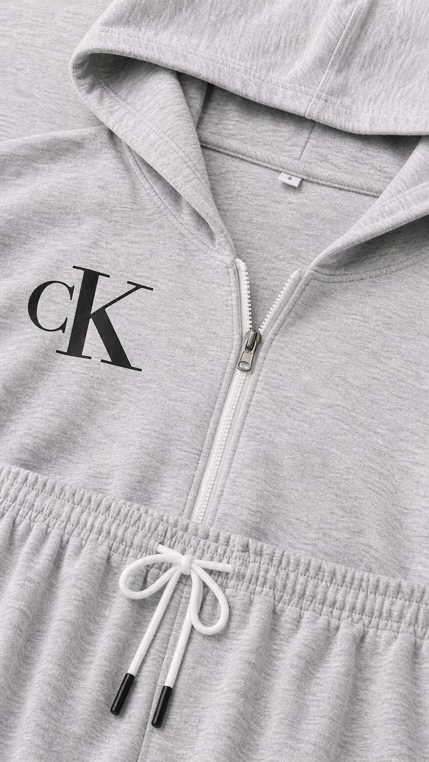 Close up view of heather grey hoodie zipper, logo print detail, and drawstring elastic waistband