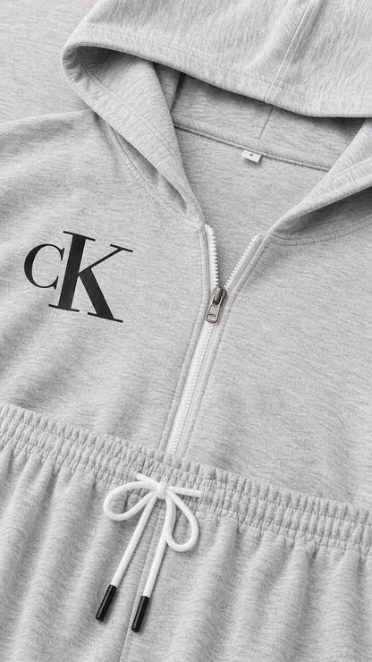 Close up view of heather grey hoodie zipper, logo print detail, and drawstring elastic waistband