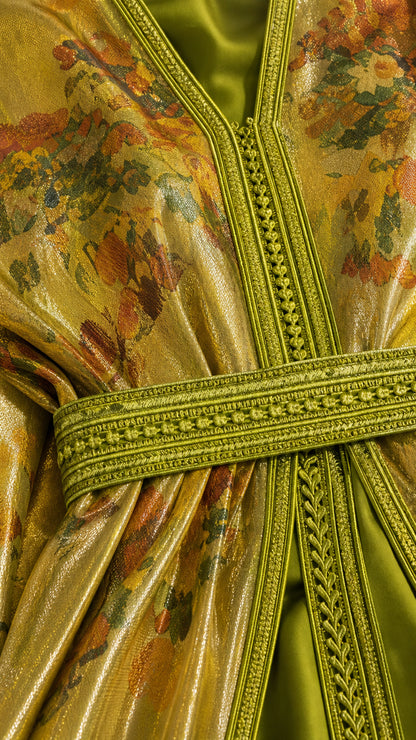 Close-up detail of the intricate braided embroidery trim and metallic floral texture