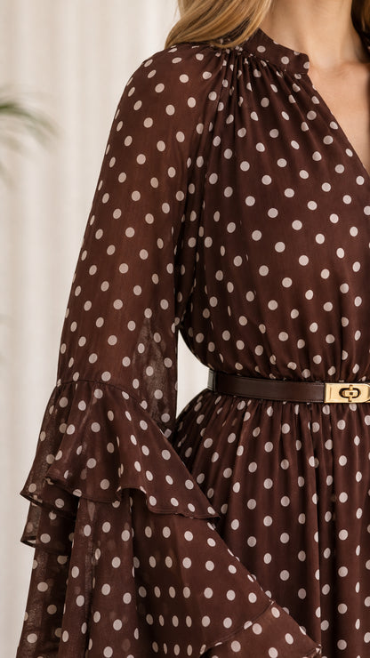 Close-up detail of tiered bell sleeve and gathered V-neck on brown polka dot dress