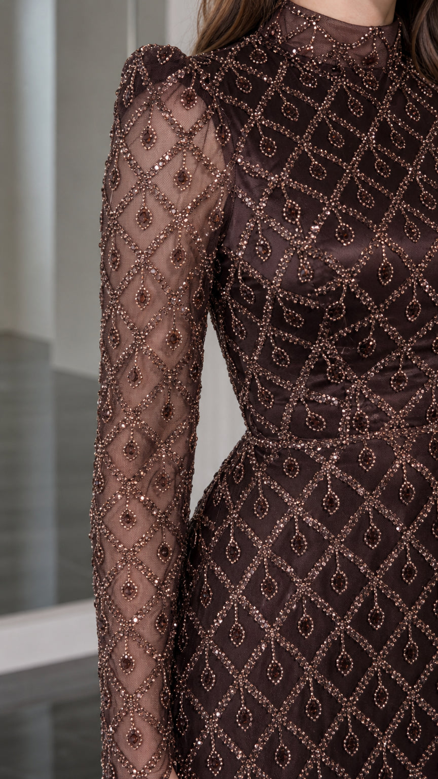 Close-up detail of geometric diamond beading, high neckline, and puff shoulder on gown