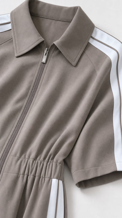 Close up detail of collar zipper and shoulder stripe on taupe jumpsuit