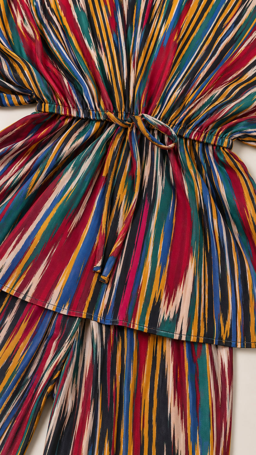 Close-up detail of pleated texture and drawstring tie waist on multicolor blouse